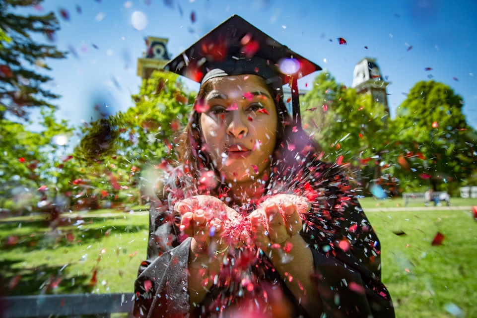 Graduate Celebrating on Old Main Lawn